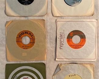 Six 45 rpm records featuring Ricky Nelson, Buddy Holly, Dean Martin, Nat King Cole, and more