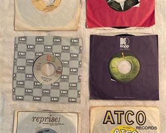 Six 45 rpm records featuring Donna Summer, Ringo Starr, Stray Cats, Badfinger, Turtles, and Sonny and Cher