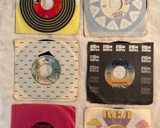 Six 45 rpm records featuring Cher, Manilow, Alice Cooper, Roberta Flack, Moody Blues, and more