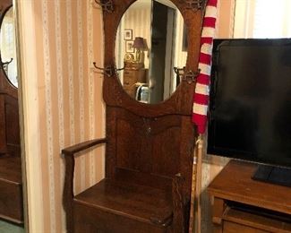 Antique American carved tiger oak hall tree/seat stand with storage.