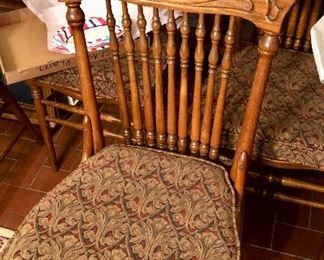 Tiger oak pressed back spindle dining chairs. Natural hand woven cane seat. Seven available.