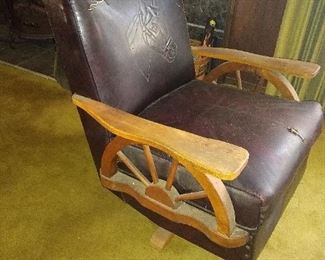 Vintage 1950s wagon Wheel leather chair with horse motif. A couple of small tears in the leather.