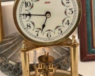 Antique Kundo Anniversary Clock	12 in high by 6.5 diameter	
