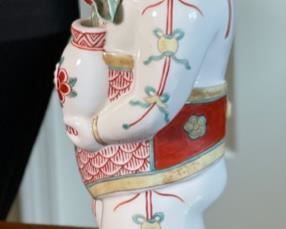 Chinese Porcelain Figurine Man with Flowers		
