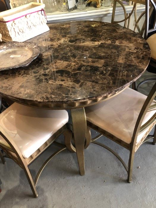 Marble 44" round top "Emperador"  brown on gold tone metal  curved legs, with 4 matching chairs.  The cream silk Like texture fabric has the original plastic cover, so the fabric is in original condition with no stains.  $375.00