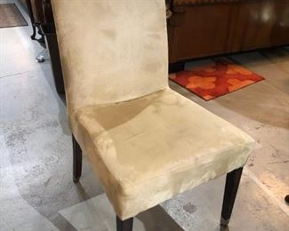 One of four armless parson chairs with chrome feet and the back has a chrome ring too