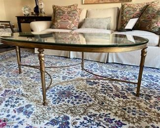 Brass and glass oval cocktail table. Measures 52" x 32" W x 19" H. Photo 2 of 3.