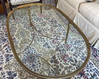 Brass and glass oval cocktail table. Measures 52" x 32" W x 19" H. Photo 1 of 3.
