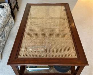 Vintage two-self cane-top cocktail table. Measures 26" x 42" x 18" H. Photo 1 of 3.