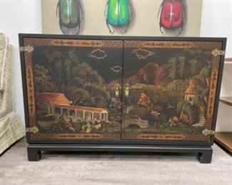 Vintage ebony chinoiserie sideboard with Asian motif. Measures 48" W x 13" D x 32" H.
