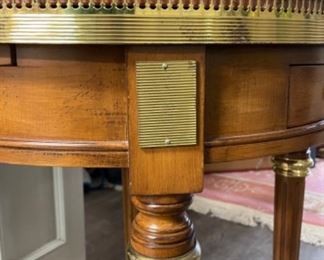 Vintage side table with marble top and brass gallery. Has two drawers and two hidden pull out drink trays. Measures 24” D x 27” H. Photo 3 of 4.