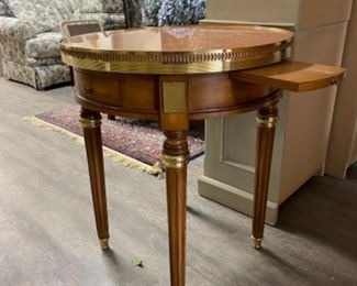 Vintage side table with marble top and brass gallery. Has two drawers and two hidden pull out drink trays. Measures 24” D x 27” H. Photo 1 of 4.