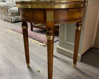 Vintage side table with marble top and brass gallery. Has two drawers and two hidden pull out drink trays. Measures 24” D x 27” H. Photo 4 of 4.