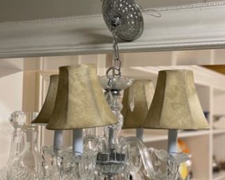 4 arm crystal chandelier. Measures 20” x 20”.