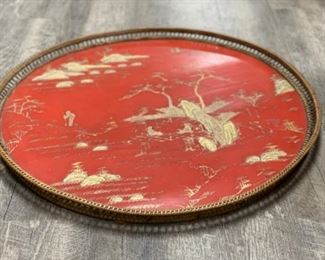 Red chinoiserie oval tray with rattan frame. Measures 24" D.