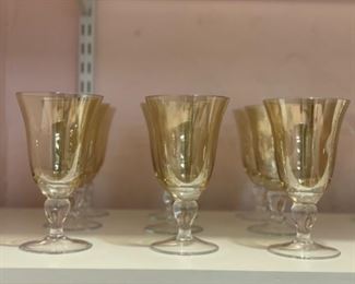 Set of 9 yellow colored water glasses.