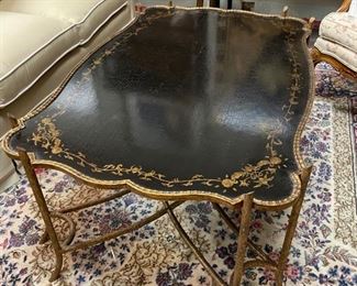 Dessin Fournir black lacquer crackle finish cocktail table with gilt details and frame. Measures 49" x 32" x 20" H. Photo 1 of 2.
