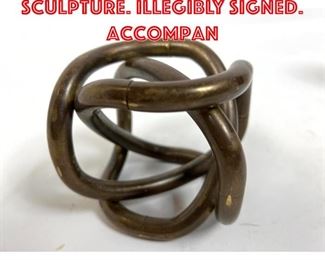 Lot 89 Signed Metal Knot Sculpture. Illegibly signed. Accompan