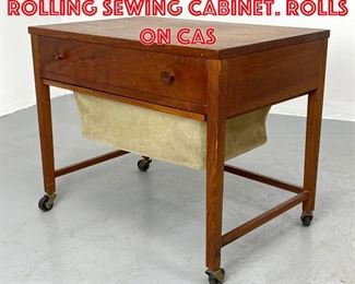 Lot 316 Danish Modern Teak Rolling Sewing Cabinet. Rolls on cas