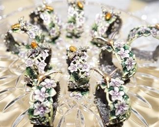 Set of silver napkin rings with applied enamelled florals and butter flies.... weddings are coming up. Give them a heirloom gift they will cherish.