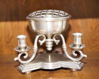 flower frog and candle holder centerpiece . White metal
