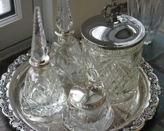 Two cut glass cologne bottles , rouge jar and canniser for what you need with tray of silverplate