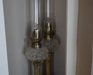 French style antique mantel lamps with glass pattern fonts and column acanthus accent brass stems on brass platforms.