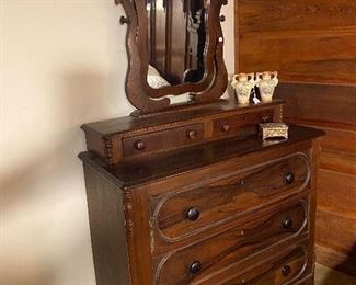 Dainty mirror atop this beautiful walnut dresser!