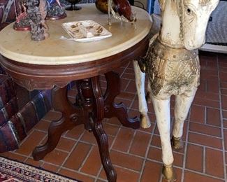 Look at this wooden horse and marble top walnut table!