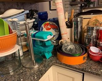 tons of kitchen gadgets, tupperware, blue glass ware