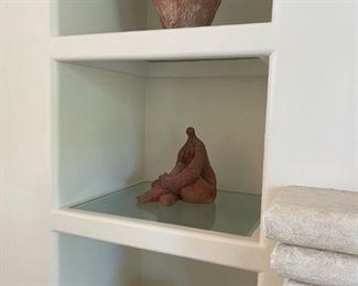 Sculpture by Fern Jaffee she studied at the Art Institute of Chicago. Her clay works are exaggerations of the female figure with emphasis on earth-bound solidarity. 