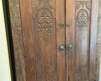 Wood armoire with shelves and drawers inside.