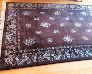 100% wool brown floral rug, made in Belgium. 67” x 97” not including fringe (has some sun fading)