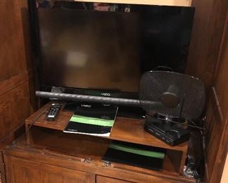 Interior of entertainment center - front doors open & retract. With 2010 Vizio 31” TV (Model E321VA) & Radio Shack antenna. 