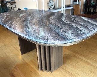 Marble top table - likely made by Bendixen. Top is a rounded rectangle shape. (39” x 69” x 28.5”H) Very heavy! Some sun fading on base.