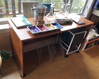 Teak veneer desk (return) on wheels (51”L, 19”D, 27”H) + champagne bucket, glass decanters, file carts & more