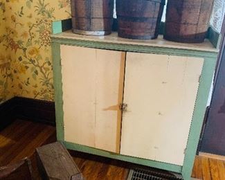 many pieces of primitive furniture plus notice the three old locally made barrels and the old animal trap on the floor