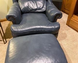 Pair of matching “Classic Leather” chairs with matching ottomans