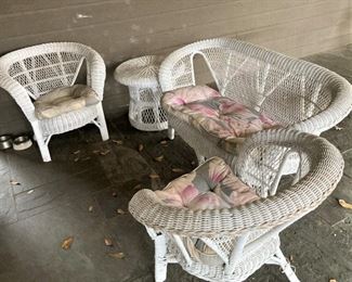 White wicker chairs, small table, and settee