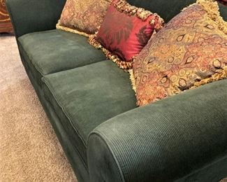 Dark green sofa; decorative pillows