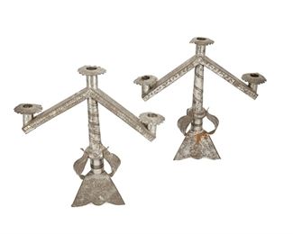 10
A Pair Of Sand-Weighted Tin Candelabra
Circa 1940s; Mexico
Each three-light candelabrum with floral and leaf motifs and chased designs, 2 pieces
Each: 13.25" H x 13" W x 4.75" D
Estimate: $200 - $300