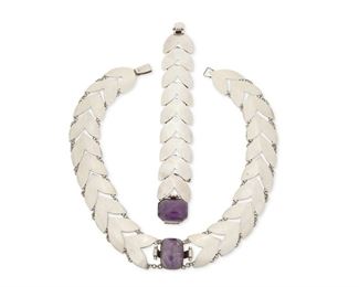 17
A Set Of Fred Davis Silver And Amethyst Jewelry
Pre-1948; Mexico City, Mexico
Each stamped with FD for Fred Davis; Further stamped: Silver / Mexico / Made in Mexico
Comprised of a chevron link necklace featuring a large cushion-shaped cabochon amethyst and a matching link bracelet with clasp closure

2 pieces
Necklace: 16.5" L x 1.125" H; Bracelet: 7.25" L x 1.125" H
115.25 grams gross
Estimate: $1,500 - $2,000