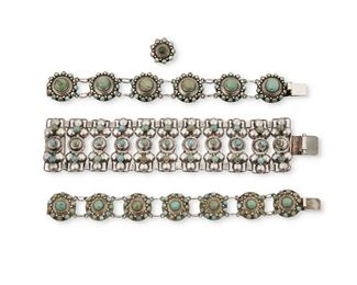 19
A Group Of Fred Davis Silver And Turquoise Jewelry
Pre-1948; Mexico City, Mexico
Each stamped with FD for Fred Davis; Further stamped: Silver / Mexico / Made in Mexico
Comprising a matching pair of stylized medallion and cluster-set turquoise link bracelets (each: 7.25" L x .75 and 0.875" H) with matching cluster-set turquoise ring (ring size: 5.75), and a wide row-set turquoise link bracelet (7.5" L x 1.5" H)

4 pieces
188.6 grams gross
Estimate: $1,200 - $1,800