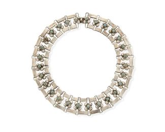 21
A Fred Davis Silver And Turquoise Necklace
Mid-20th Century; Mexico City, Mexico
Stamped: FD [conjoined] / Sterling / Mexico
Comprising a collar necklace consisting of openwork links with square clusters of silver half-spheres and central cabochon turquoise, with a clasp closure
15.5" L x 1.125" H
130.7 grams
Estimate: $600 - $800