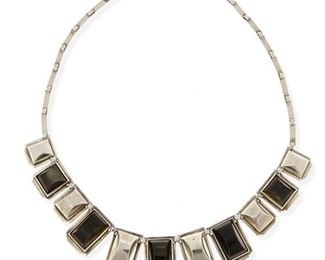 22
A Fred Davis Silver And Obsidian Necklace
Pre-1948; Mexico City, Mexico
Stamped with conjoined FD for Fred Davis
A necklace comprised of alternating set obsidian and silver architectural panels suspended on a narrow silver link chain with hook clasp
19" L x 1" H
68.0 grams
Estimate: $500 - $700