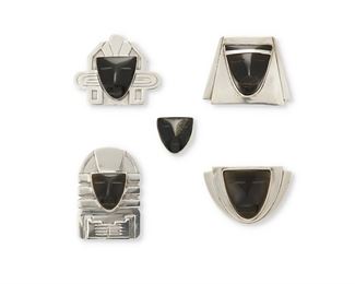 25
A Group Of Fred Davis Silver And Hardstone Jewelry
Pre-1948; Mexico City, Mexico
Each stamped with FD for Fred Davis; One brooch further stamped: Silver / Made in Mexico
Comprising one carved onyx mask brooch, three carved obsidian mask brooches, and an obsidian carved mask ring

5 pieces
Largest brooch: 1.625" H x 2" W; Ring size: 6
97.5 grams gross
Estimate: $500 - $700