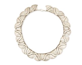 39
A Héctor Aguilar Silver Necklace
1940-1945; Mexico
Stamped: HA / Sterling / Made in Mexico
The delicate necklace designed with alternating spade and point-form links with raised linework, strung on thin rope wire with a hook clasp
18" L x 1" H
119.3 grams
Estimate: $800 - $1,200