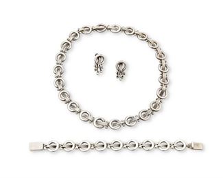 43
A Set Of Héctor Aguilar Silver Jewelry
1948-1962; Taxco, Mexico
Each stamped: HA [conjoined] / Taxco; Further variously stamped: .940 / [Eagle 9]; Necklace: [Eagle 3]; Bracelet: 940
Comprising a necklace of circular links and wire elements (16.5" L x 0.5" H), a matching bracelet (7" L x 0.5" H), and a pair of matching screw-back earrings with dangles (1" L)

4 pieces
135.8 grams gross
Estimate: $600 - $800