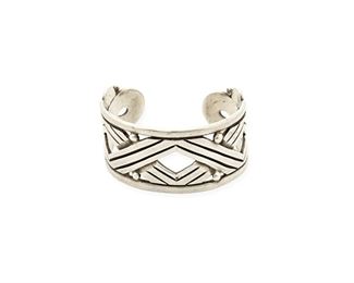 55
A Héctor Aguilar Silver Cuff Bracelet
1940-1945; Taxco, Mexico
Stamped: HA / Taxco / 940
A cuff with an alternating zig-zag motif and ball spacers, with rounded terminals
7.375" total inner C x 1.375" H, wrist opening: 1.125"
86.7 grams
Estimate: $700 - $900