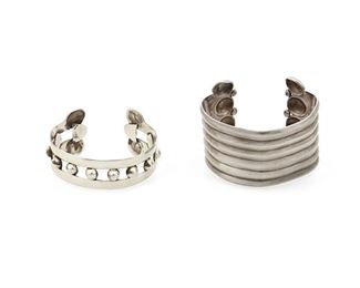 58
Two Héctor Aguilar Silver Cuff Bracelets
1943-1948; Taxco, Mexico
Each stamped for Héctor Aguilar; Each further stamped: Made in Mexico / Sterling
Comprising an openwork bracelet with curved terminals and silver balls (6.75" total inner C x 1.5" W, wrist opening: 1") and a solid ridged bracelet with curved incised terminals (7" total inner C x 2.375" H, wrist opening: 1.125")

2 pieces
141.0 grams
Estimate: $600 - $800